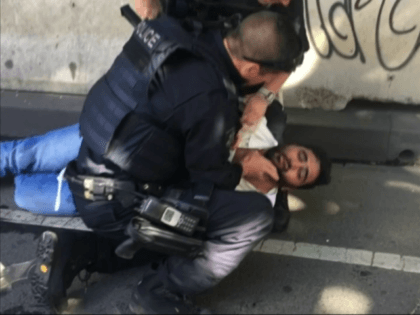 In this image taken from video made available by Lachlan V, an afghan refugee is held by police after a car was driven into pedestrians on a busy Melbourne intersection in Melbourne, Australia Thursday Dec. 21, 2017. Australian police said two men have been arrested after a car was deliberately …