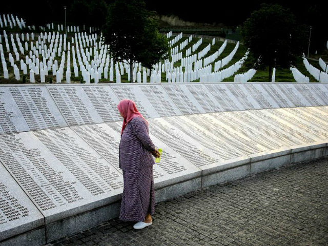 SREBRENICA, BOSNIA AND HERZEGOVINA - JULY 11: A woman reads name of the victims on the mem