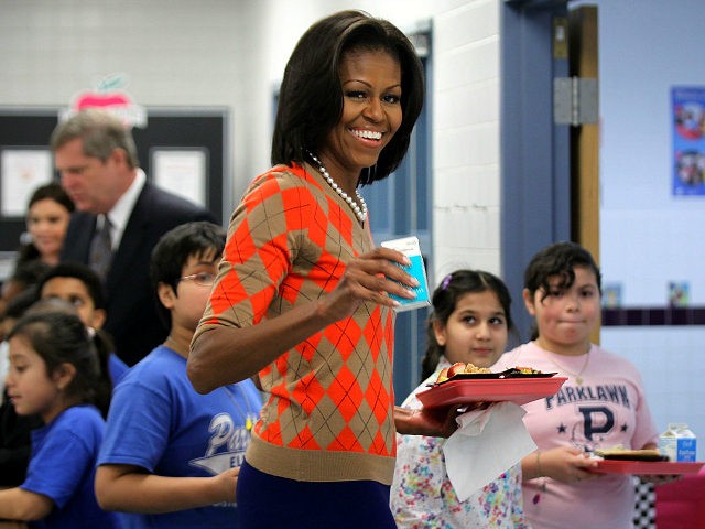 ALEXANDRIA, VA - JANUARY 25: U.S. first lady Michelle Obama joins students at the food line to pick up lunch items at the cafeteria of Parklawn Elementary School January 25, 2012 in Alexandria, Virginia. The first lady, accompanied by Agriculture Secretary Tom Vilsack and celebrity cook Rachael Ray, visited the …