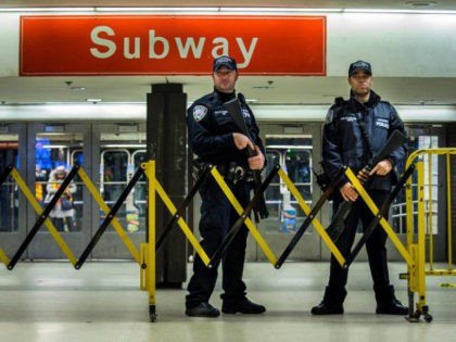 Police stand guard inside the Port Authority Bus Terminal following an explosion near Time