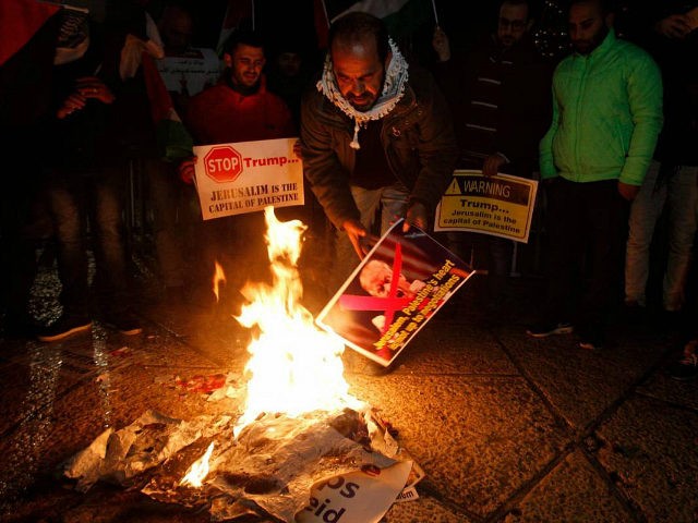 Palestinian demonstrators burn posters of the US president in Bethlehem's Manger Square in protest to him declaring Jerusalem as Israel's capital on December 6, 2017. Abbas said the United States can no longer play the role of peace broker after Donald Trump's decision on Wednesday to recognise Jerusalem as Israel's …