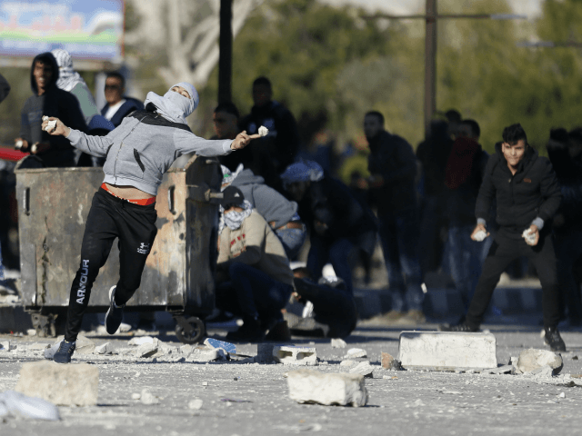 Palestinians clash with Israeli troops following a protest against U.S. President Donald T