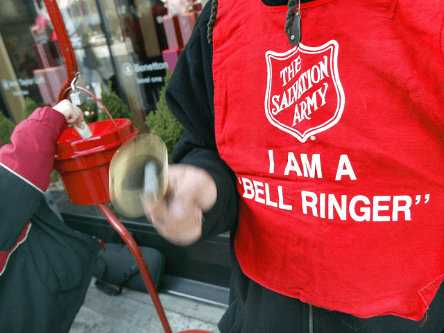 A donation is made as Salvation Army bell ringer Ruben Rios works outside a store November