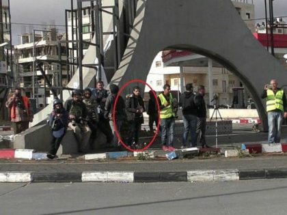 A Palestinian attacker, hiding among journalists, before he stabbed a Border Police officer in the West Bank city of Ramallah on December 15, 2017. (Israel Police)