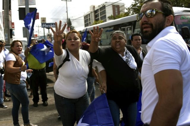 Supporters of Honduran President Juan Orlando Hernandez take part in a march on December 7
