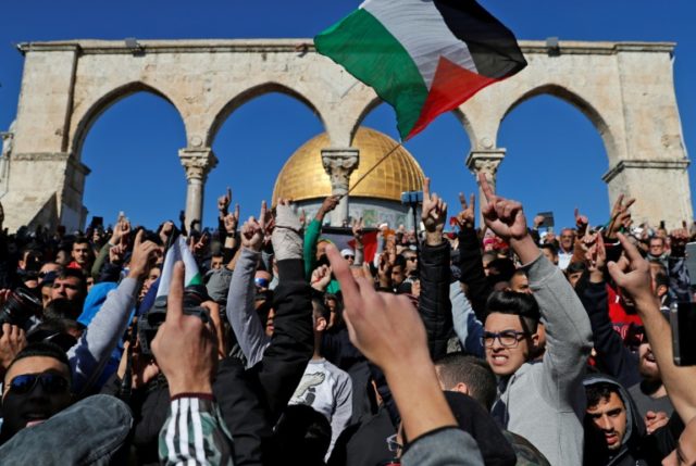 Palestinian Muslim worshippers shout slogans during Friday prayer at the Al-Aqsa mosque co