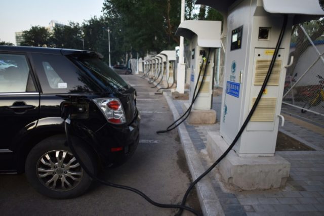 A BYD electric car charges at a charging station in Beijing on September 11, 2017