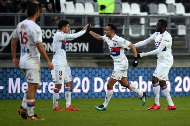 Lyon's forward Houssem Aouar (2ndL) is congratulated by teammates after scoring a goal dur