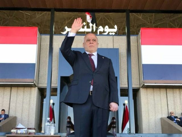 A handout picture released by the Iraqi parliament shows Prime Minister Haider al-Abadi gr