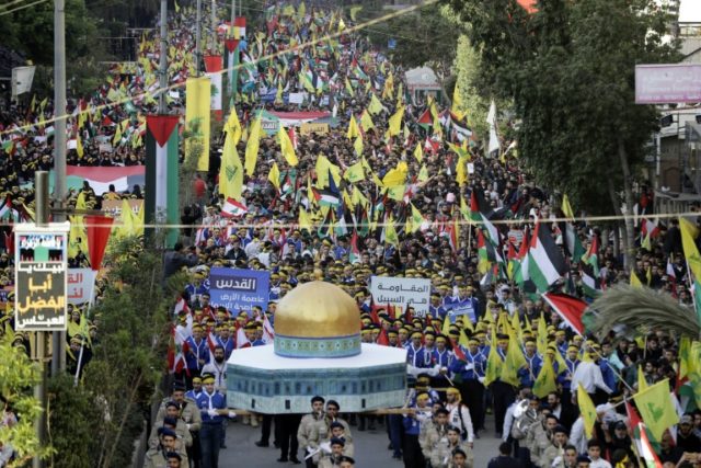 Lebanese demonstrators march with a model of the Dome of the Rock, along with their nation