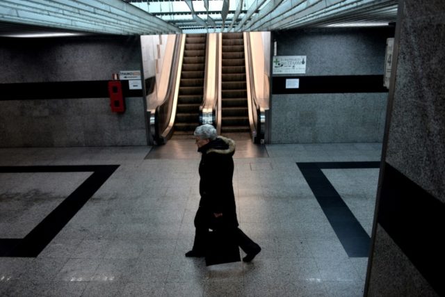 A woman walks in a train station during a 24-hour general strike in Thessaloniki on Decemb