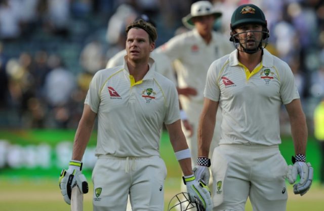 Australia captain Steve Smith (front-L) and teammate Shaun Marsh leave the field at the en