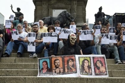 Journalists protest against violence during a commemoration of the 30th anniversary of the murder of Mexican journalist Manuel Buendia at the Angel de la Independencia monument in Mexico City
