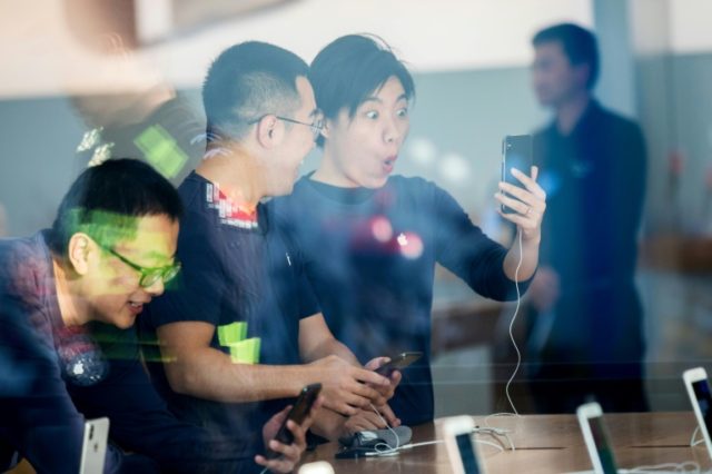 Chinese customers look at the new iPhone X at the Apple store in Hangzhou in November 2017