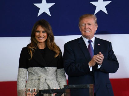 US President Donald Trump (R) and First Lady Melania smile upon arriving at US Yokota Air