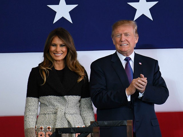 US President Donald Trump (R) and First Lady Melania smile upon arriving at US Yokota Air