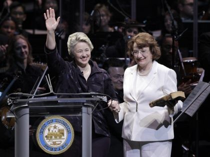 Houston Mayor Annise Parker, left, waves as her partner, Kathy Hubbard, right, holds the Bible during a public inauguration ceremony Monday, Jan. 4, 2010 in Houston. Houston is the largest U.S. city to elect an openly gay mayor. (AP Photo/David J. Phillip)