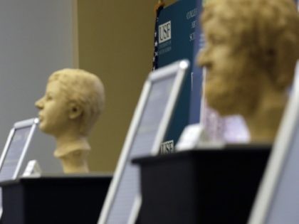 In this Oct. 21, 2016 photo, Dr. Erin Kimmerle, standing next to forensic sculptures of un