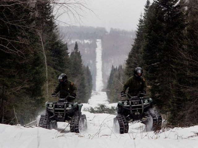 Border Patrol agents patrol northern border on ATVs.