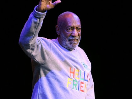 FILE - In this Nov. 21, 2014 file photo, comedian Bill Cosby waves to the crowd as he walk