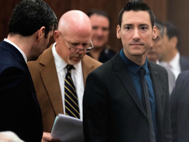 David Daleiden, right, one of the two anti-abortion activists indicted last week, leaves the courtroom with attorney's Peter Breen, left, and Terry Yates, center, after turning himself in to authorities Thursday, Feb. 4, 2016, in Houston. Daleiden and Sandra Merritt are charged with tampering with a governmental record, a felony punishable by up to 20 years in prison. (AP Photo/Bob Levey)