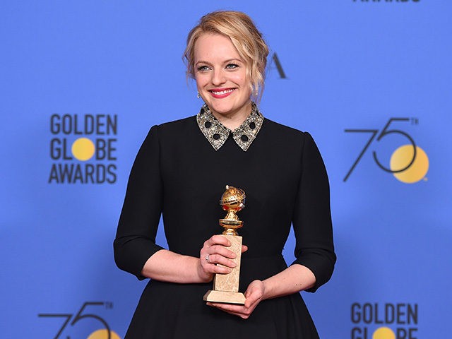 Elisabeth Moss poses in the press room with the award for best performance by an actress i