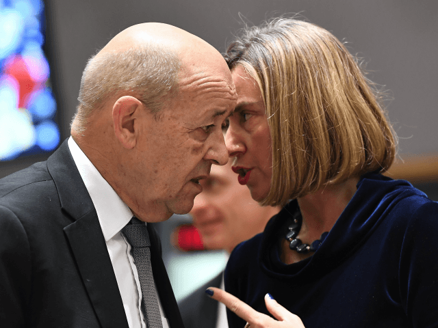 France's Foreign Minister Jean-Yves Le Drian (L) and EU foreign policy chief Federica Mogherini speak together as they arrive for a foreign affair council at the European Council in Brussels, January 22, 2018. / AFP PHOTO / EMMANUEL DUNAND (Photo credit should read EMMANUEL DUNAND/AFP/Getty Images)