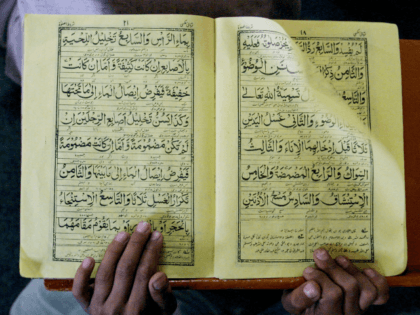 395410 05: A student reads a textbook at the Islamic religious school, Tajdal Quran madras