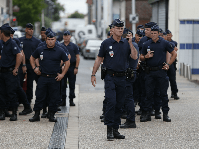 Police officers stand on guard in the streets of Saint-Etienne-du-Rouvray on July 26, 2016