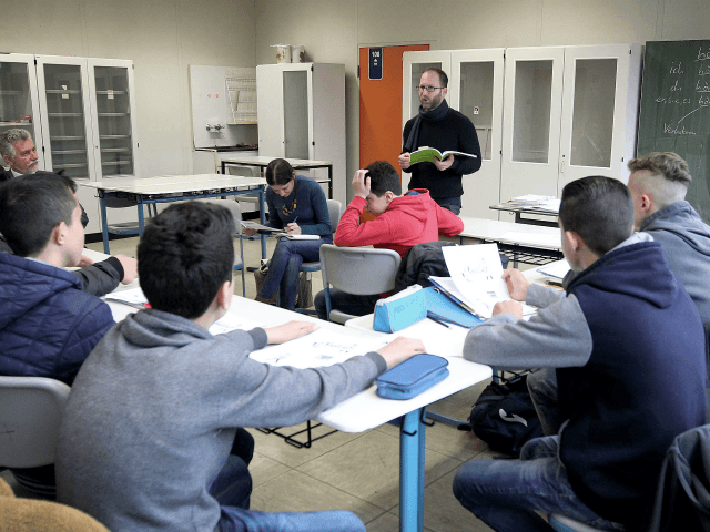 Refugee students attend a leeson in their classroom at the Heinrich-von-Brentano-School in