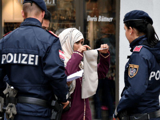 Police officers ask a woman to unveil her face in Zell am See, Austria, on October 1, 2017. Austria's ban on full-face Islamic veils comes into force following similar measures in other European countries. / AFP PHOTO / APA / BARBARA GINDL / Austria OUT (Photo credit should read BARBARA …