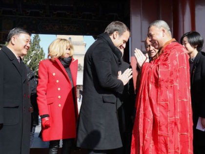 French President Emmanuel Macron (C) and his wife Brigitte Macron (center-L) are greeted by a monk during a visit at the Big Wild Goose Pagoda in the northern Chinese city of Xian on January 8, 2018. Macron on January 8 launched a state visit to China in Xian -- the …