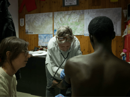 A 26 year old migrant from Guinea is treated for suspected tuberculosis by two doctors of NGO 'Rainbow for Africa' as he arrives in Bardonecchia on January 12, 2018. Migrants are now trying to reach France crossing the Italian Alps by the snow-covered pass Colle della Scala (Col de l'Echelle) …