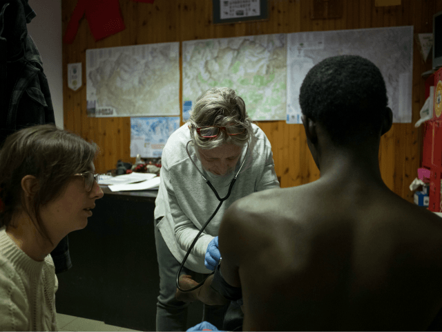 A 26 year old migrant from Guinea is treated for suspected tuberculosis by two doctors of