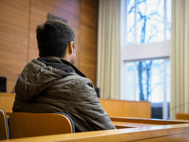 The defendant, an Afghan asylum seeker, accused of stabbing to death a compatriot mother-of-four because he was furious she had converted to Christianity, waits at a courtroom before his trial on January 23, 2018 at a district court in Traunstein, southern Germany. Prosecutors charge that the 30-year-old, who was not …