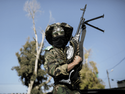 A Palestinian militant from the Ezzedine al-Qassam brigade, the armed wing of Hamas, poses