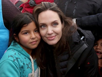 The U.N. refugee agency's special envoy, actress Angelina Jolie poses with a Syrian child during her visit to the Zaatari Syrian Refugee Camp, in Mafraq, Jordan, January 28, 2018. (AP Photo/Raad Adayleh)