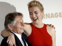British actress Kate Winslet, right, poses with film director Roman Polanski before the premiere of his movie "Carnage", in Paris, Sunday, Nov. 20, 2011. (AP Photo/Christophe Ena)