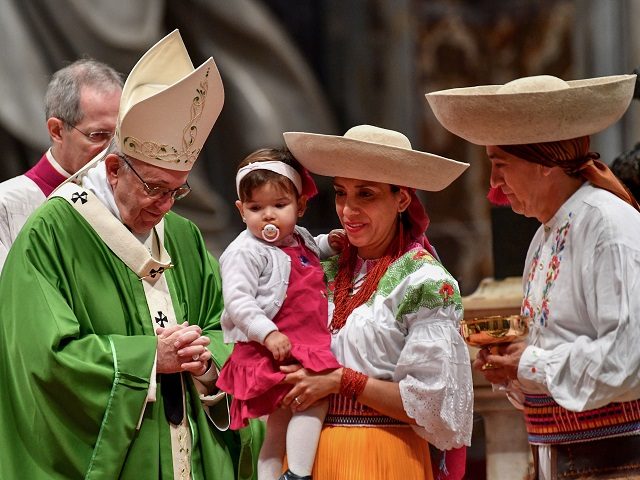 Pope Francis (L) leads a mass marking the World day of Migrants and Refugees on January 14
