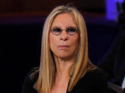 Singer/actress Barbra Streisand (L) and designer Donna Karan (2nd-L) sit among other audie