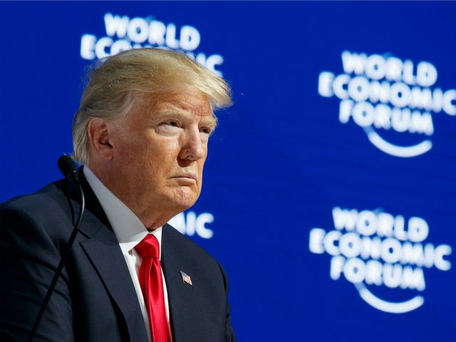 President Donald Trump listens as he is introduced to deliver a speech to the World Econom