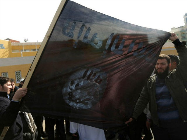 Palestinian Salafists deploy a giant al-Qaeda-affiliated flag during a protest against the printing of satirical sketches of the Prophet Mohammed by French satirical weekly Charlie Hebdo on January 19, 2015 on their way to the French Cultural Centre in Gaza city. The walls of Gaza's French Cultural Center were painted …