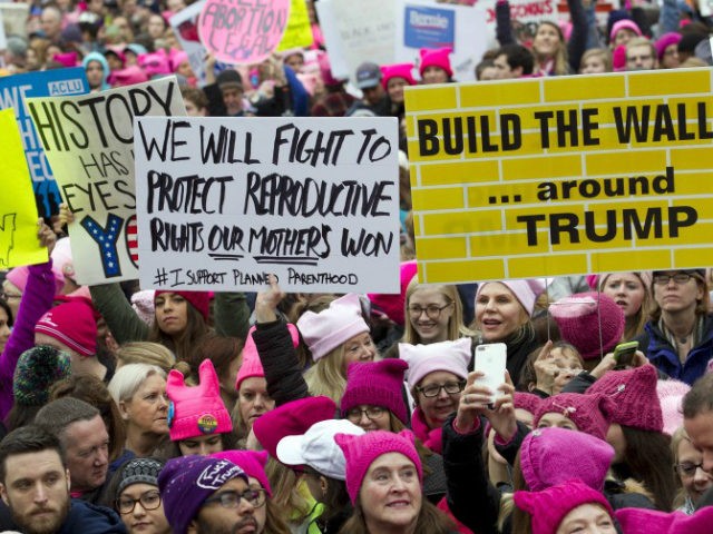 Women with bright pink hats and signs begin to gather early and are set to make their voic