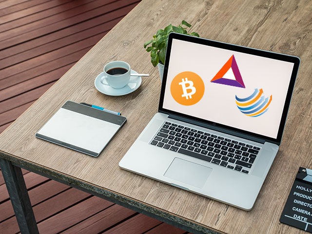 A laptop featuring the logos of Bitcoin (BTC), the Basic Attention Token (BAT), and Factom