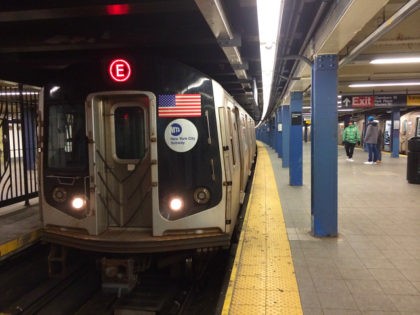 E train arrives at World Trade Center subway station .