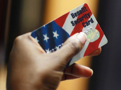NEW YORK - FEBRUARY 10: Kethia Dorelus a social worker with the Cooperative Feeding Program displays a Federal food stamps card that is used to purchase food on February 10, 2011 in Fort Lauderdale, Florida. Recent statistics show that nationwide, one in seven Americans receives help from the Federal government …