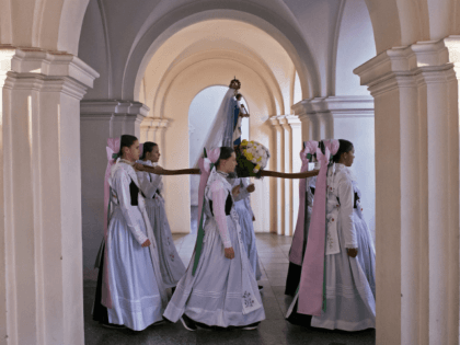 Women dressed in the traditional clothes of the Sorbs carry the statue of Virgin Mary during a procession in the church in Rosenthal, eastern Germany, Monday, June 5, 2017. Traditionally on Whit Monday catholic faithful Sorbs, a Slavic minority near the German-Polish border, celebrate an open air mass in the …