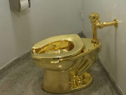 A fully functioning solid gold toilet, made by Italian artist Maurizio Cattelan, is going into public use at the Guggenheim Museum in New York on September 15, 2016. A guard will be stationed outside the bathroom to protect the work, entitled 'America', which recalls Marcel Duchamp's famous work, 'Fountain'. / …