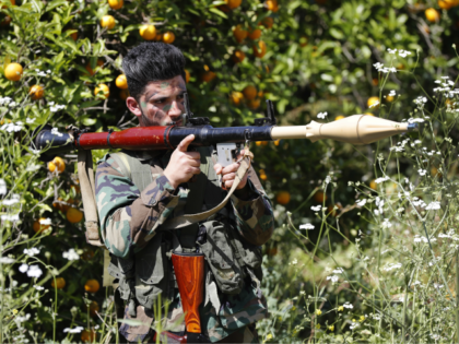 A Hezbollah fighter holds an RPG as he takes his position between orange trees, at the coastal border town of Naqoura, south Lebanon, Thursday, April 20, 2017. Hezbollah organized a media tour along the border with Israel meant to provide an insight into defensive measures established by the Israeli forces …