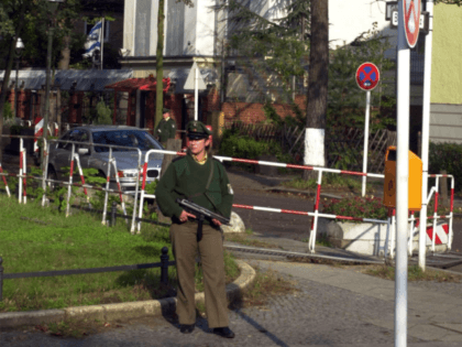 A German police officer stands guard close to the Israeli embassy in Berlin, Friday, Otober 13, 2000. Heavy and violent conflicts in the mideast keep the police protecting embassies more attentive. (AP Photo/Axel Seidemann)